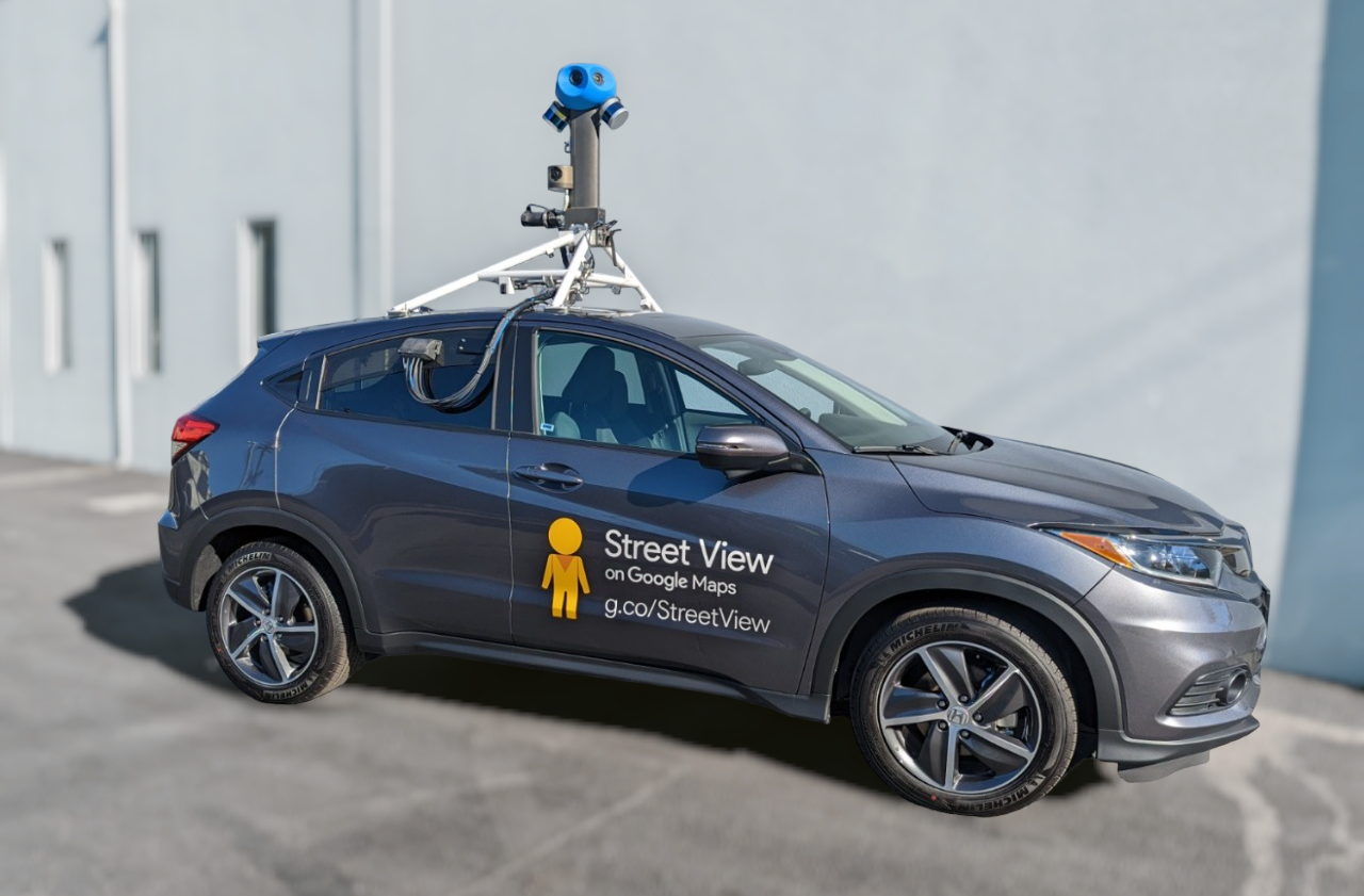 A parked street view car with its massive camera strapped to the roof